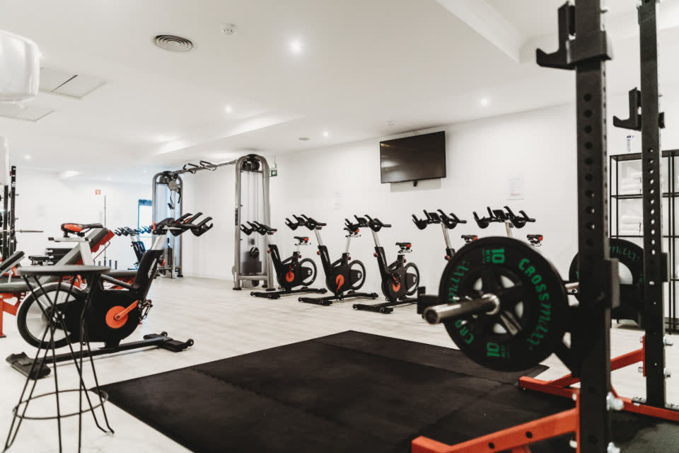 Sala de treino com bicicletas e equipamentos de musculação